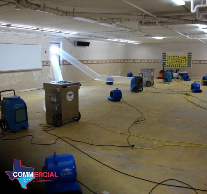 Commercial flood cleanup with air movers drying the floor