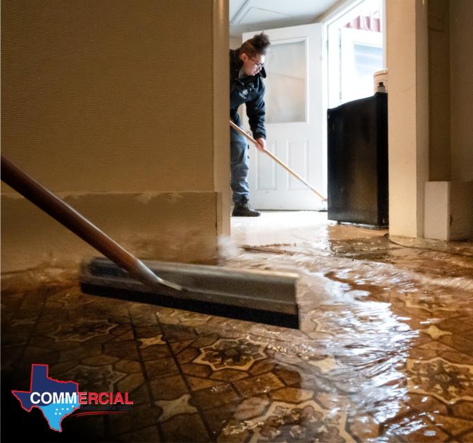 Crew pushing floodwater with a squeegee