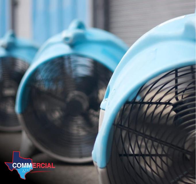 Emergency water damage restoration air mover in action