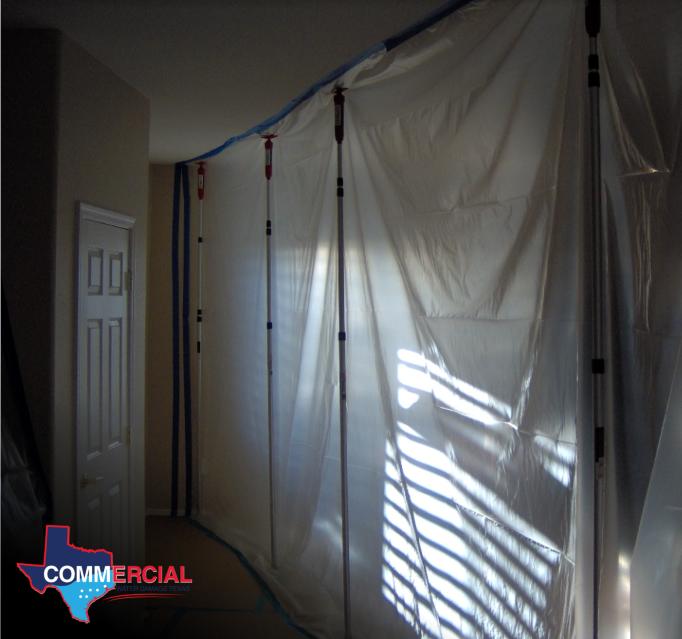 Water damage repair contractor setting up containment